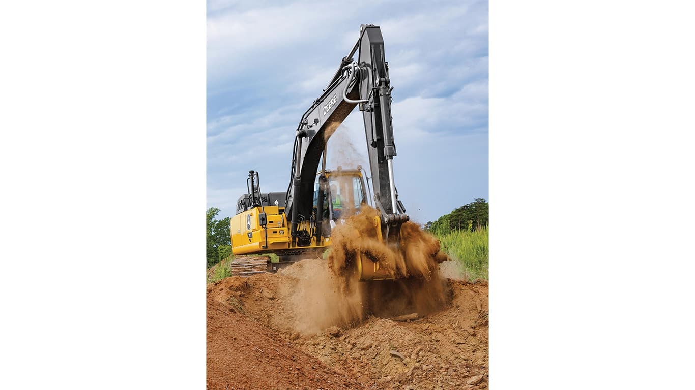 An operator using a 210P-Tier Excavator to move dirt with a green field and trees in the background. | 4re Equipment | ID: 210PEXFT4