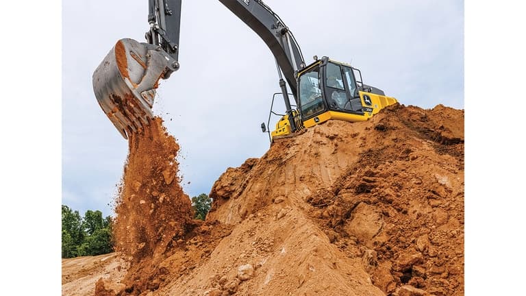 A 250P-Tier Excavator dumping dirt into a pit from the top of a stockpile. | 4re Equipment