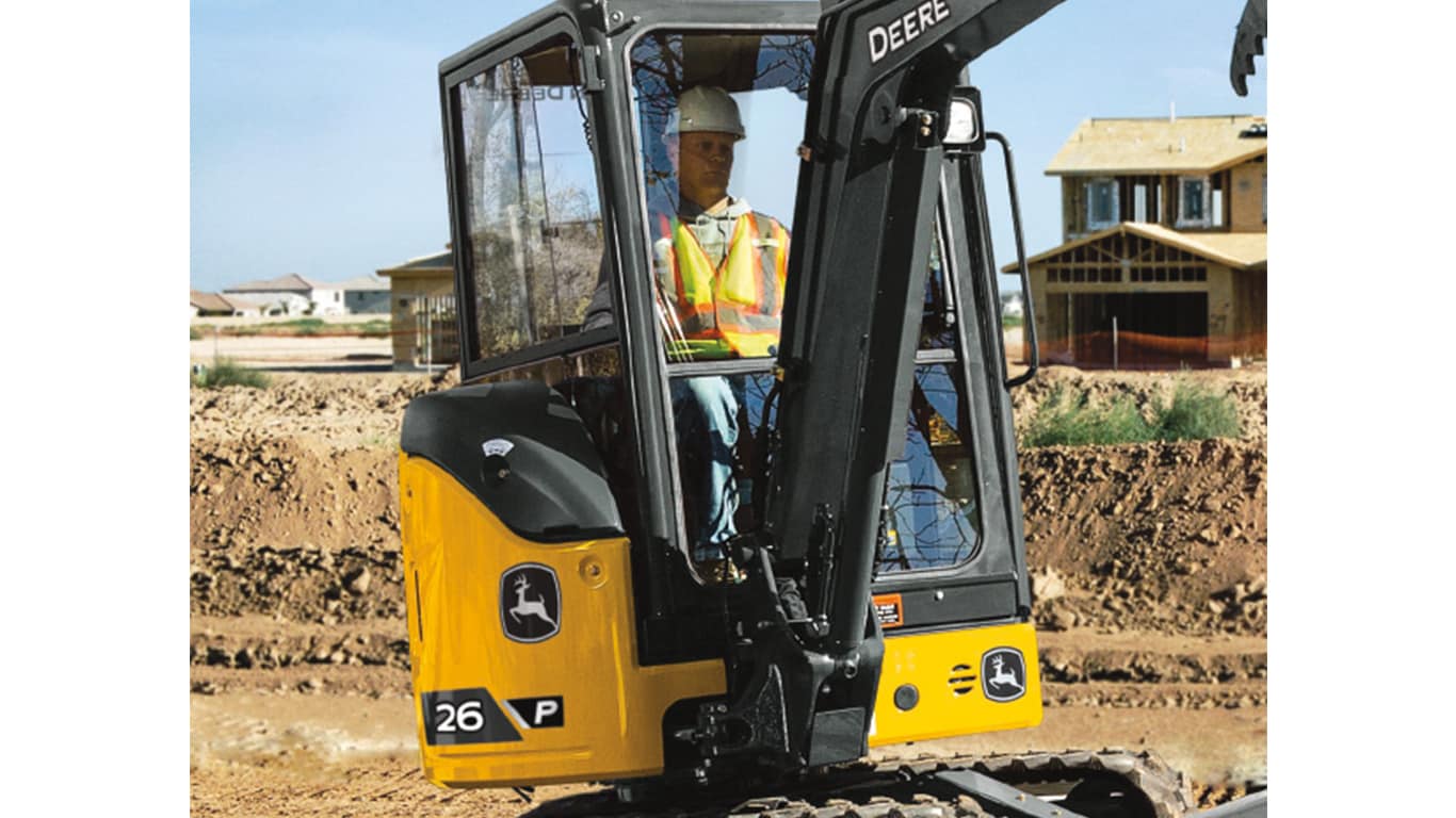 A close-up of an operator sitting in the cab of a 26P-Tier Excavator. | 4re Equipment | ID: 26PEXFT4