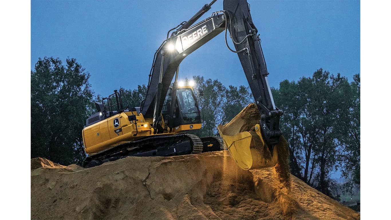 A 380P-Tier Excavator with headlights moving dirt at dusk. | 4re Equipment | ID: 380PEXFT4