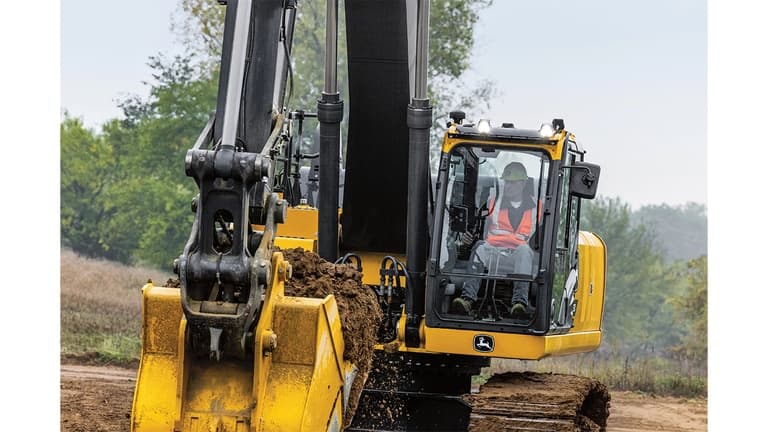 An operator using a 380P-Tier Excavator to move dirt at a worksite with trees in the background. | 4re Equipment