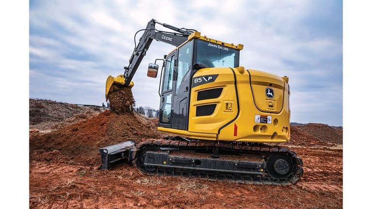 A side view of the 85P-Tier Excavator dumping dirt onto a pile at a worksite. | 4re Equipment
